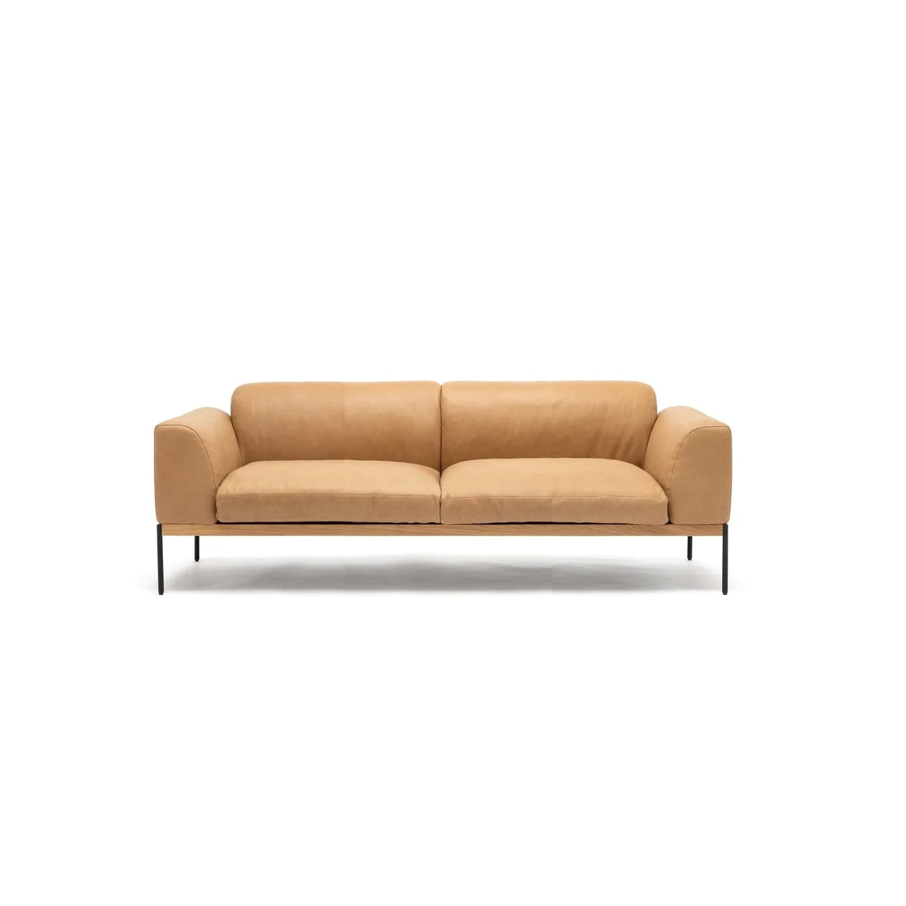 The Department Sofa 81" by Wooden Stories features tan leather, Danish-inspired lines, a low back, wide armrests, and slim black metal legs, shown against a plain white background.