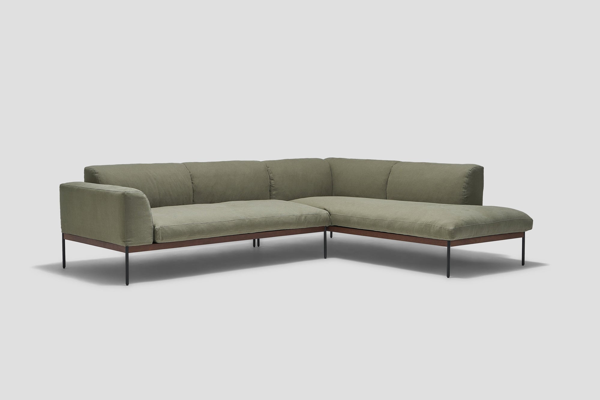 The Wooden Stories Department Modular Sofa | Fabric • M6 Right features olive green cushions, a low backrest, thin black metal legs, and an FSC-certified oak frame, shown against a plain light gray background.