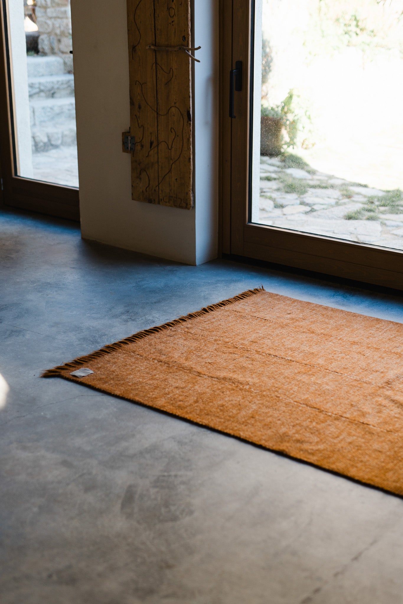 The Radhi Rug - Umber by HIMALAYAN HERMITAGE is a handwoven wool rug that brings warmth and texture to your space.