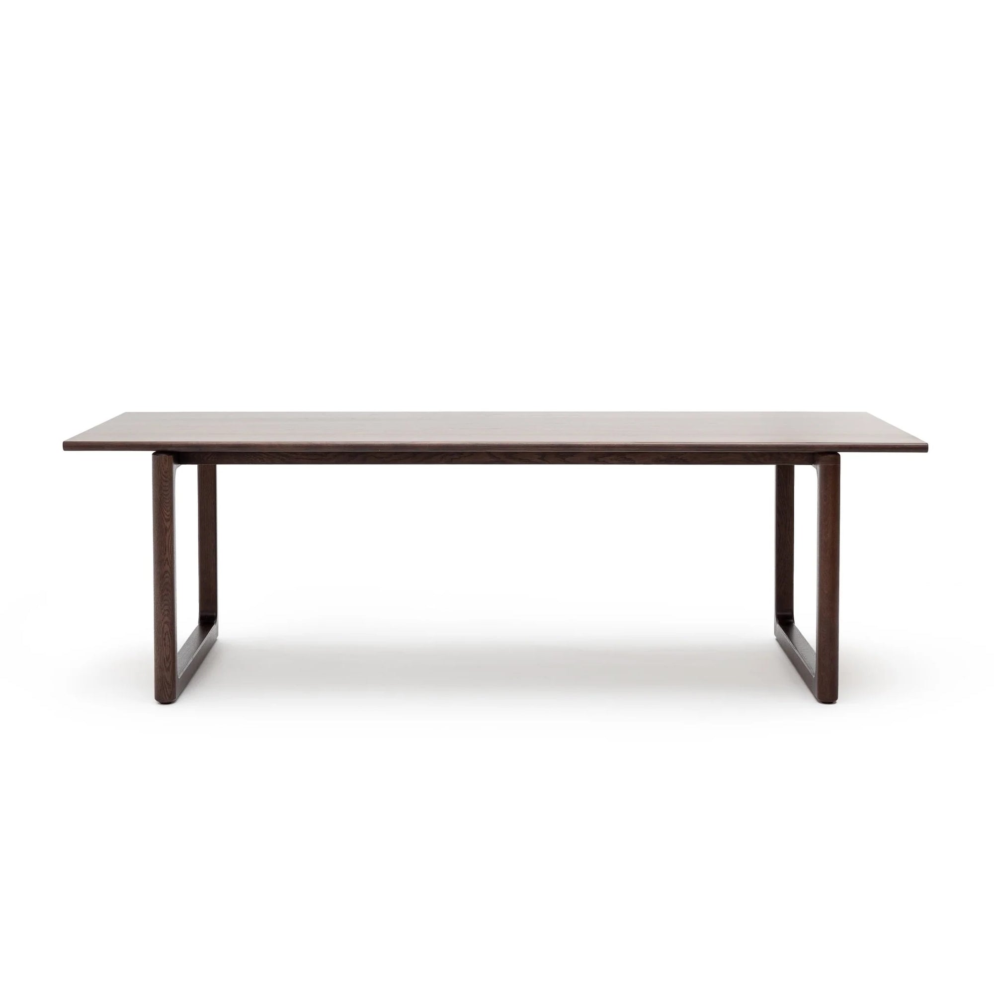 The Hover Dining Table | Espresso Oak by Wooden Stories features Danish lines, a flat top, and two wide sturdy legs on each end in a rich dark brown finish, shown against a plain white background.