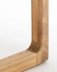 Close-up of the corner joint of the Wooden Stories Hover Dining Table in Light Oak, featuring smooth, light-colored wood with visible grain and Danish lines against a plain white background.