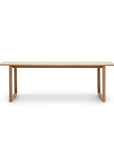 The Hover Dining Table by Wooden Stories is a minimalist, rectangular light oak table with sleek Danish lines and two sturdy end supports. Perfect for dining rooms, it's photographed against a plain white background.