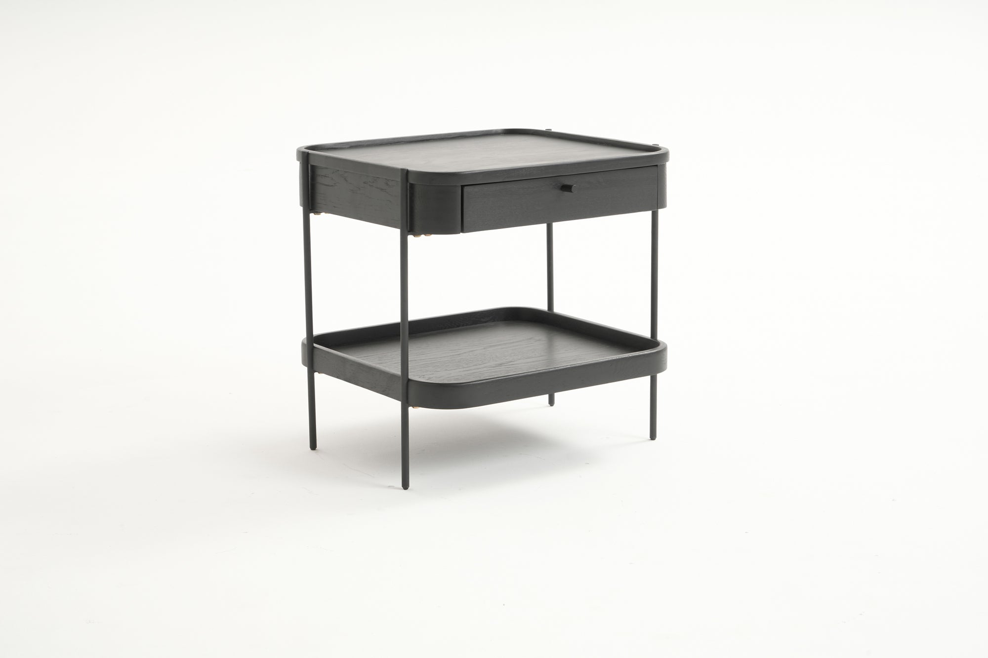 The Humla Side Table With Storage by Wooden Stories showcases a modern black finish, thin metal legs, one top drawer, and an open lower shelf, all from the Danish Collection and pictured on a plain white background.