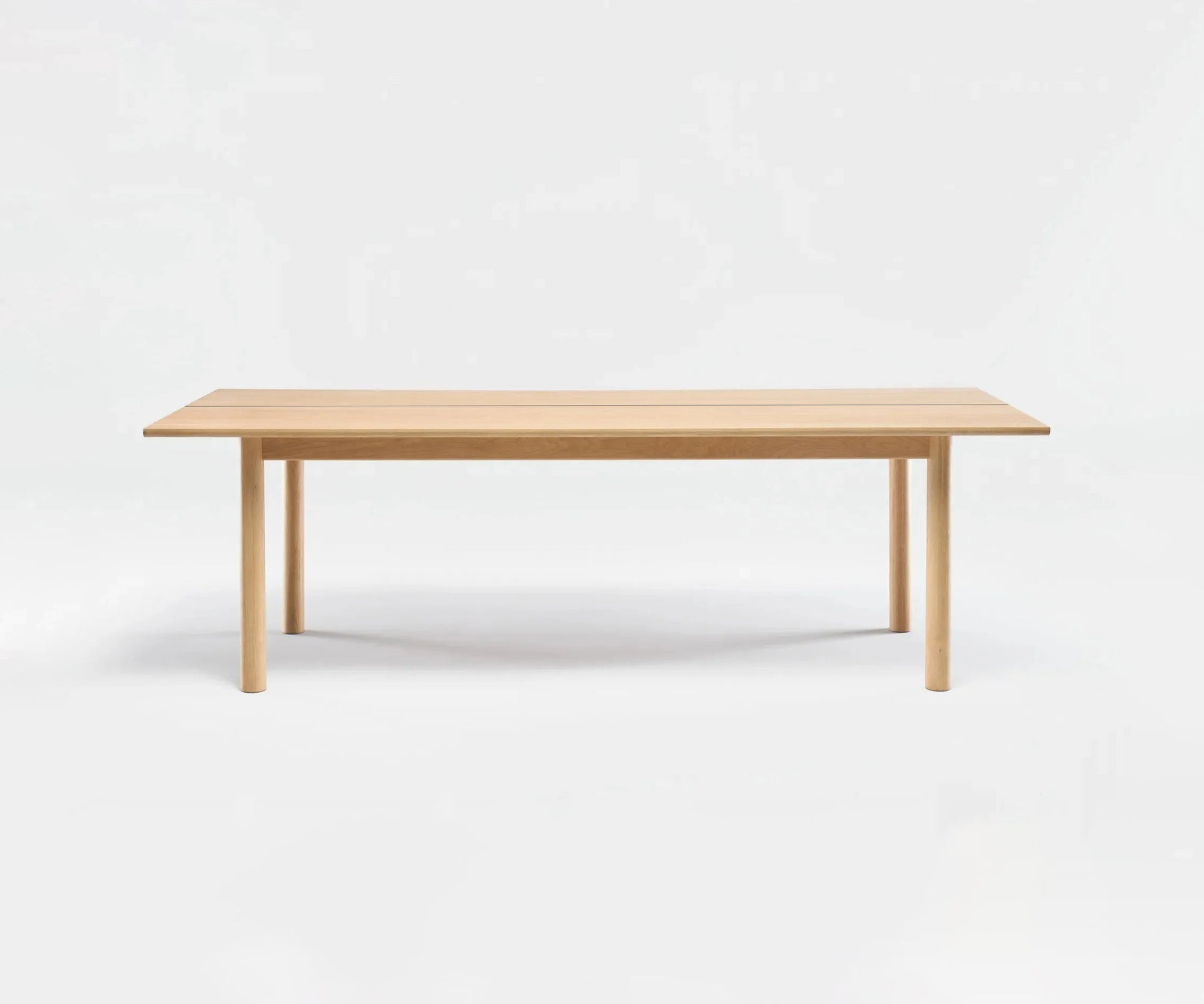 The Itamae Dining Table by Wooden Stories features a smooth light oak finish, minimalist Scandinavian design, and four straight legs, showcased against a plain white background.