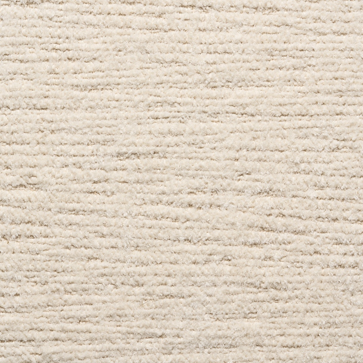 Close-up of a textured beige carpet from Natadora + Tolv's Material Swatches, featuring horizontal ridges and a soft, cozy surface—perfect for custom made-to-order designs or pairing with fabric swatches.