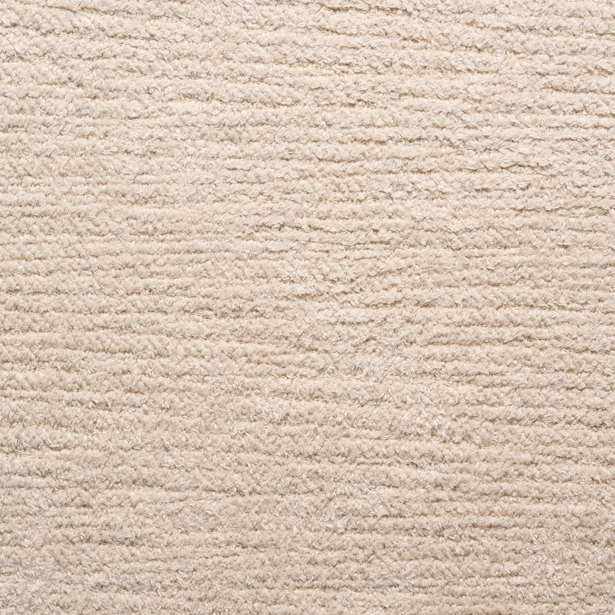 Close-up of Material Swatches by Natadora + Tolv, featuring a beige, textured carpet with horizontal ridges. The soft woven look and subtle color depth make these swatches ideal for custom made-to-order fabric coordination.