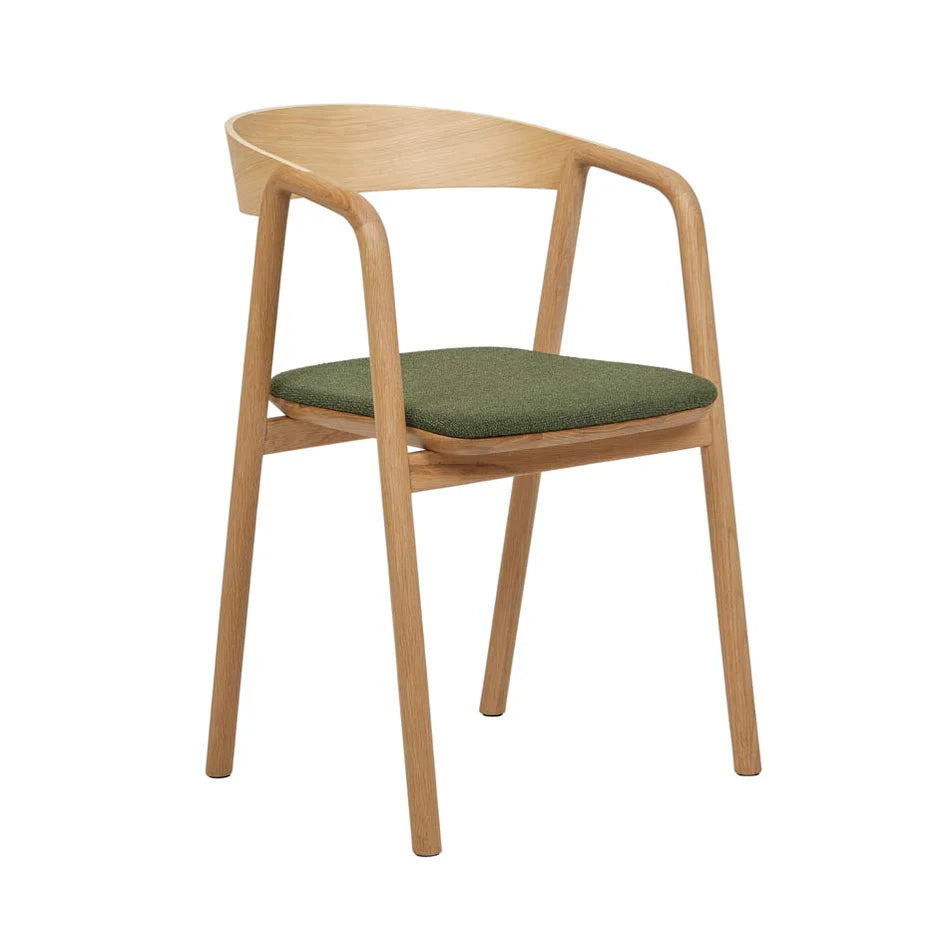 The Inlay Dining Chair | Light Oak and Fabric by Wooden Stories features a curved backrest, armrests, green upholstered seat, and angled legs, crafted from solid oak and inspired by the Danish Collection.