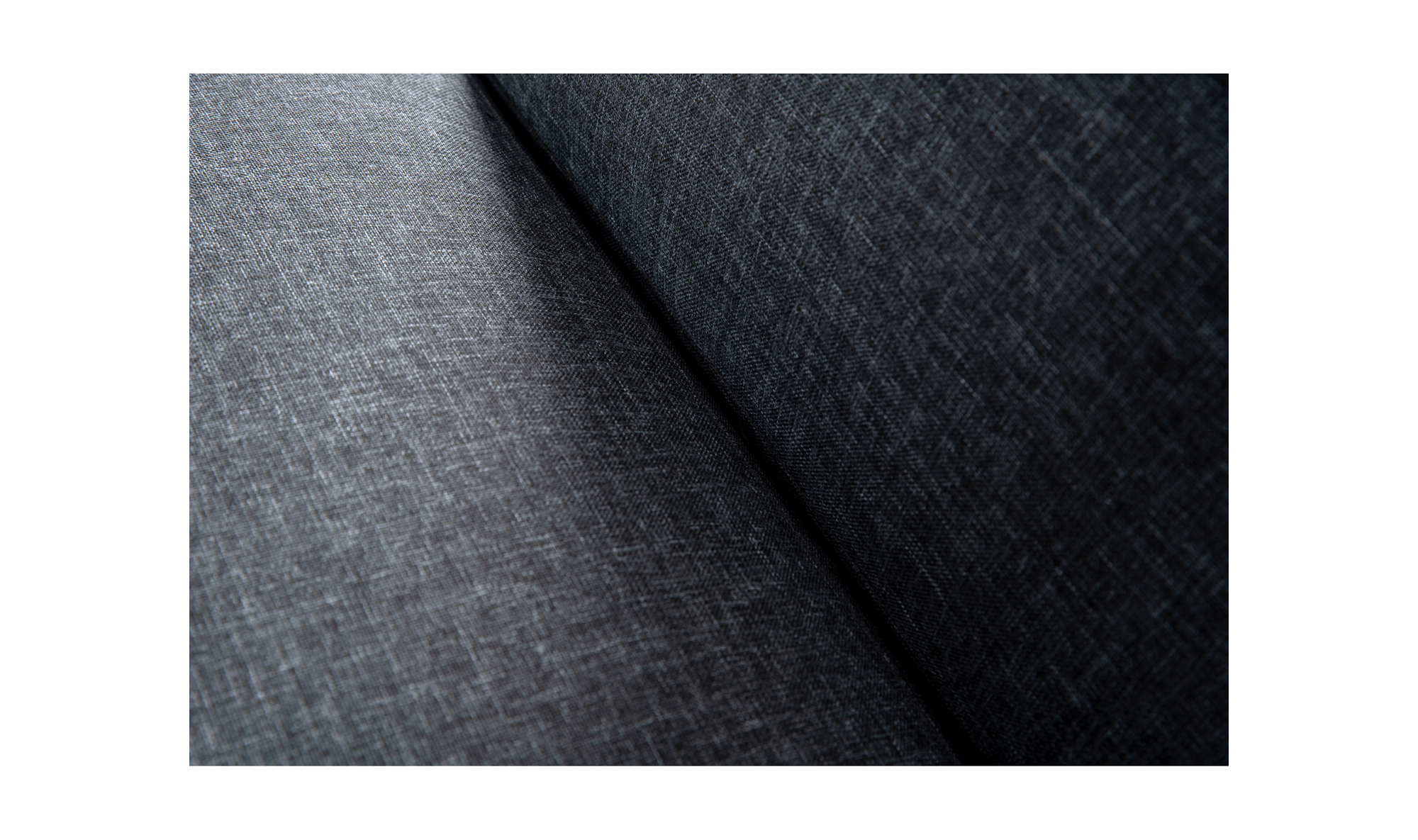 Close-up view of the seam between two dark gray olefin fabric cushions with a textured weave pattern on the Moes Morgan Outdoor Chair.
