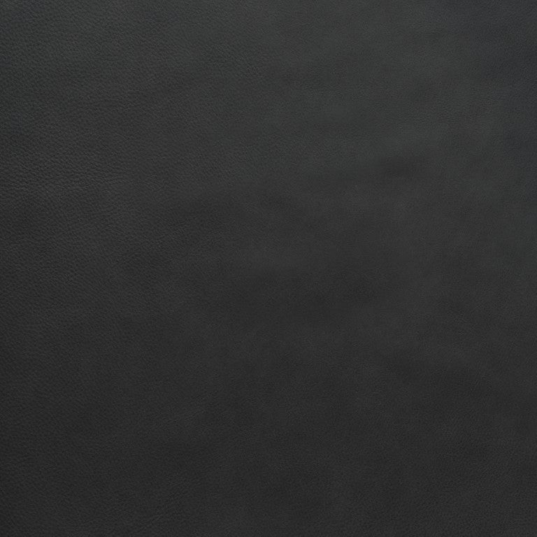 Close-up of a dark, textured surface from Wooden Stories&#39; Fabric + Leather Swatches. The material has a black leather look with subtle grain and a matte finish, ideal for custom made-to-order pieces or selecting fabric swatches.