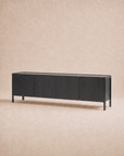 The Nell Sideboard | Black Oak by Wooden Stories features a minimalist design with four doors and clean lines, embodying Scandinavian style and set against a neutral beige background.