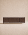 The Wooden Stories Nell Sideboard | Espresso Oak is a rectangular, dark wood sideboard featuring four cabinet doors and short legs, crafted from solid oak in an understated Scandinavian design, set against a plain beige background.