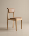 The Noki Dining Chair | Leather by Wooden Stories features a modern solid wood frame with light brown legs, a tan leather padded seat, and curved backrest—ideal for contract grade, minimalistic spaces.