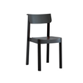 The Noki Dining Chair by Wooden Stories is crafted from solid wood with a gently curved backrest and seat in a sleek black oak finish, shown against a plain white background.