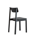 The Wooden Stories Noki Dining Chair in Black Oak features a minimalist solid wood design with a curved backrest and four straight legs, shown from the rear side on a white background—ideal contract grade seating for modern spaces.