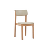 The Noki Dining Chair by Wooden Stories features a modern light oak frame with a matching curved back and beige leather seat—perfect for contract grade interiors.