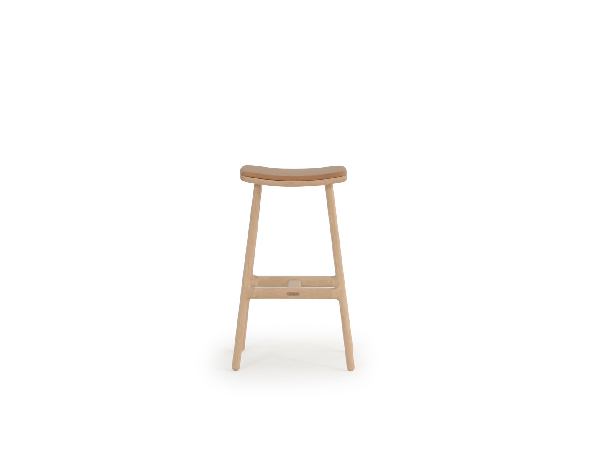 The Odd Counter Stool by Wooden Stories features a light oak frame with a leather seat. Its curved design and clean lines reflect Danish minimalism, while premium natural materials ensure both elegance and comfort. Shown on a white background.