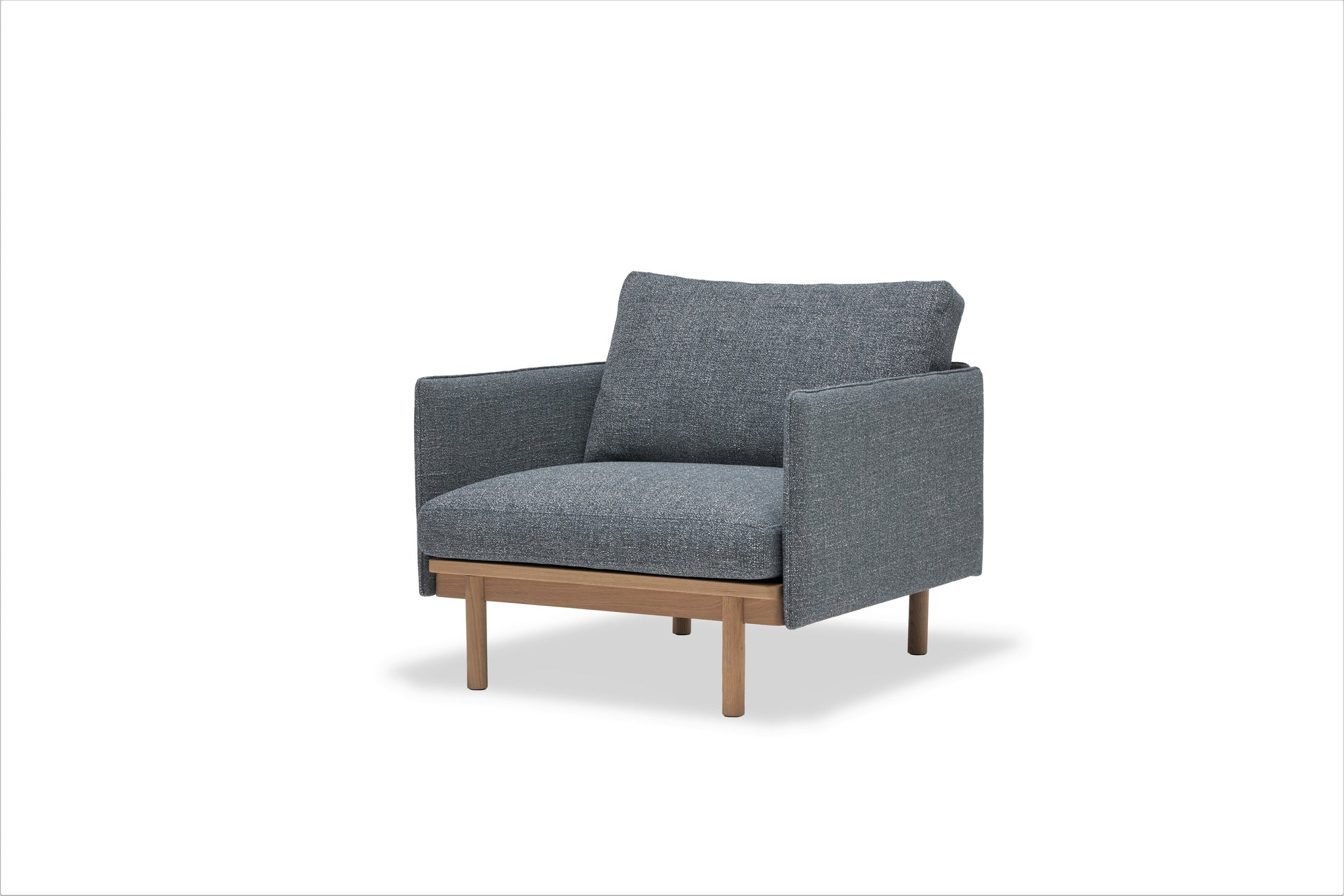 The Wooden Stories Pensive Lounge Chair | Fabric features grey upholstered cushions, Danish-inspired lines, square armrests, and wooden legs, set against a plain white background.