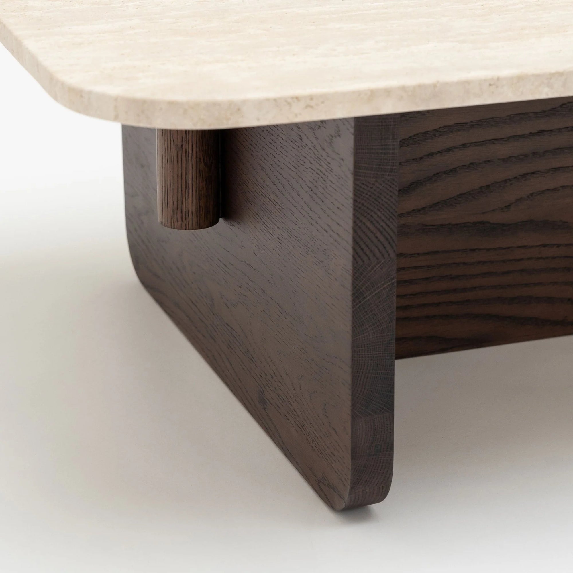 Close-up of a Pivot Coffee Table | Rectangular by Wooden Stories, showcasing a light marble top, dark solid wood base, rounded wooden support, and minimalist, clean-lined design.