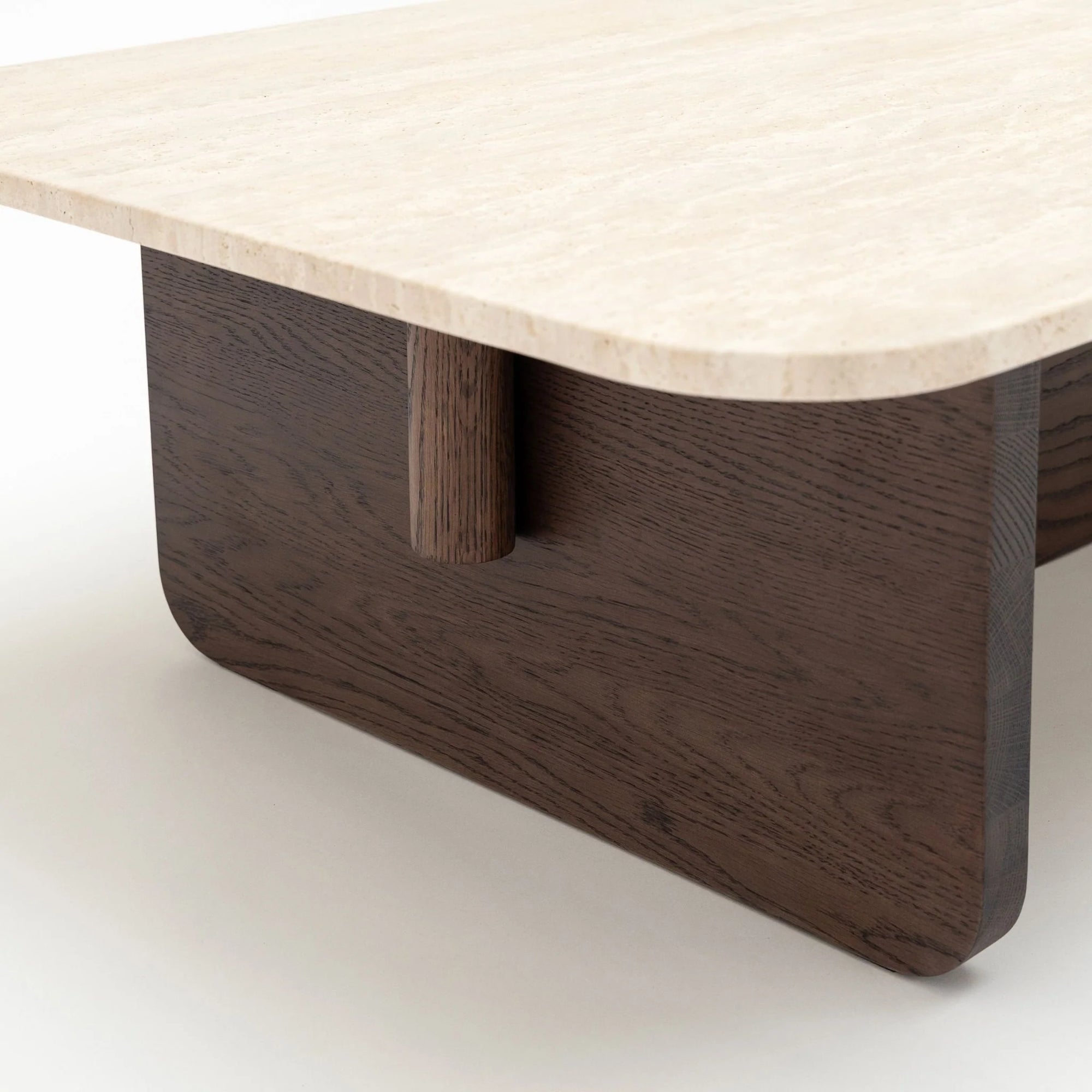 A close-up of the Wooden Stories Pivot Coffee Table | Rectangular shows its smooth, light marble top with rounded edges and a dark solid wood base featuring clean, geometric lines.