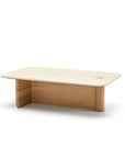 The Wooden Stories Pivot Coffee Table | Rectangular features a light wood top with rounded corners, two thick legs (one straight, one cylindrical), and a small circular hole near a corner for a unique, modern design.