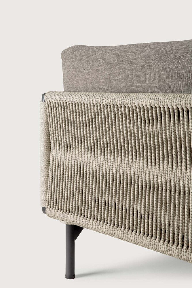 Close-up of the Ethnicraft Corbey Outdoor Sofa, featuring woven beige rope side panels, a gray cushion backrest, and black metal legs—ideal for enhancing your outdoor space against a simple light background.