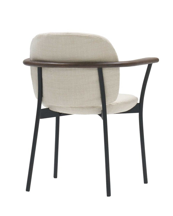 The Solace Dining Armchair | Fabric by Wooden Stories is a modern upholstered chair with a light beige seat and backrest, curved wooden armrests, and slim black metal legs, pictured from the back on a white background.