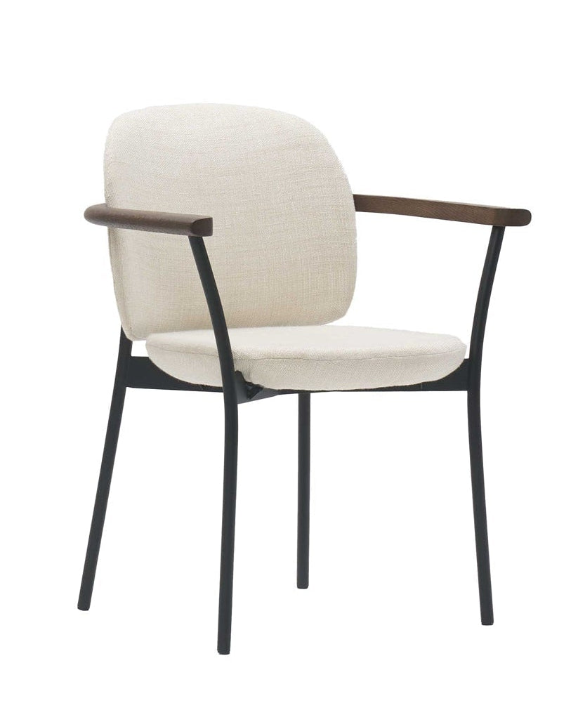 The Solace Dining Armchair | Fabric by Wooden Stories features a black metal frame, wooden armrests, and cream fabric upholstery on the seat and backrest, set against a white background.