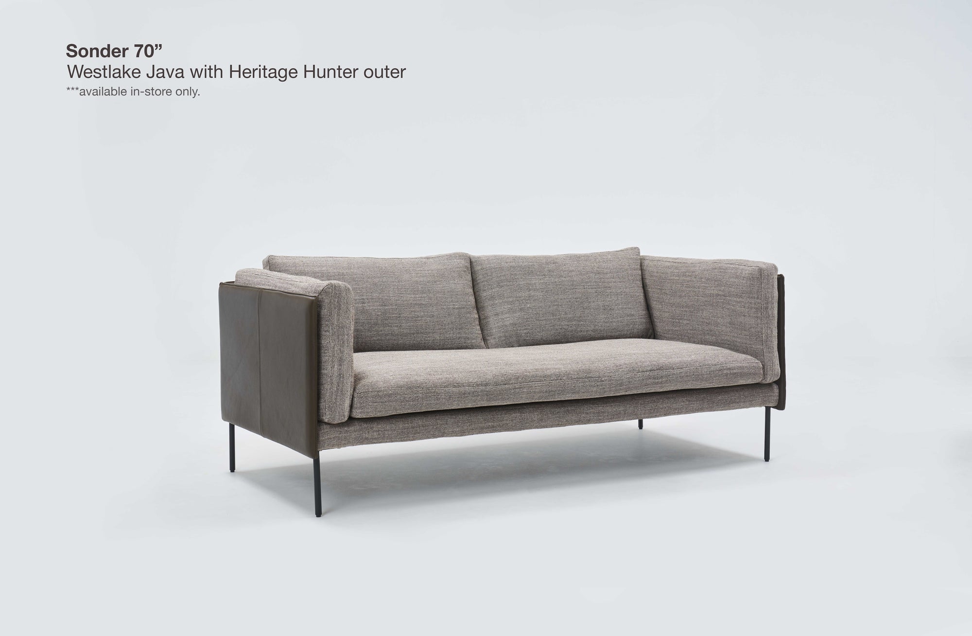 A modern gray three-seater Sonder Sofa | Fabric by Wooden Stories, featuring textured fabric feather-filled cushions, slim black legs, and dark wooden side panels, is set against a plain white background. Its subtle Danish lines and linear frame enhance the contemporary appeal. Text in the corner notes the model name and availability.