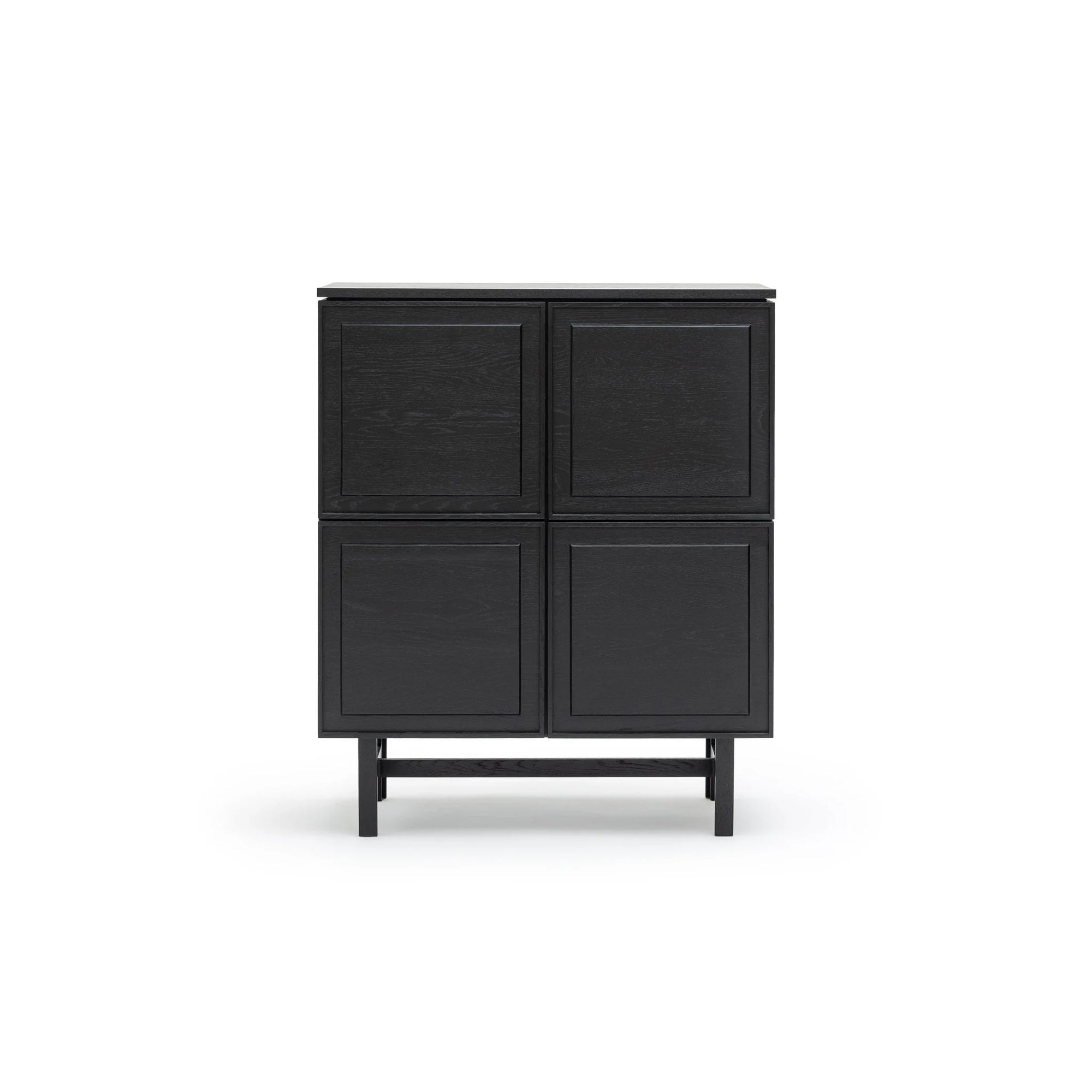 The Yorke Highboard by Wooden Stories features four square panel doors and short legs, set against a white background. Inspired by Danish design, this cabinet blends classic style with modern simplicity.
