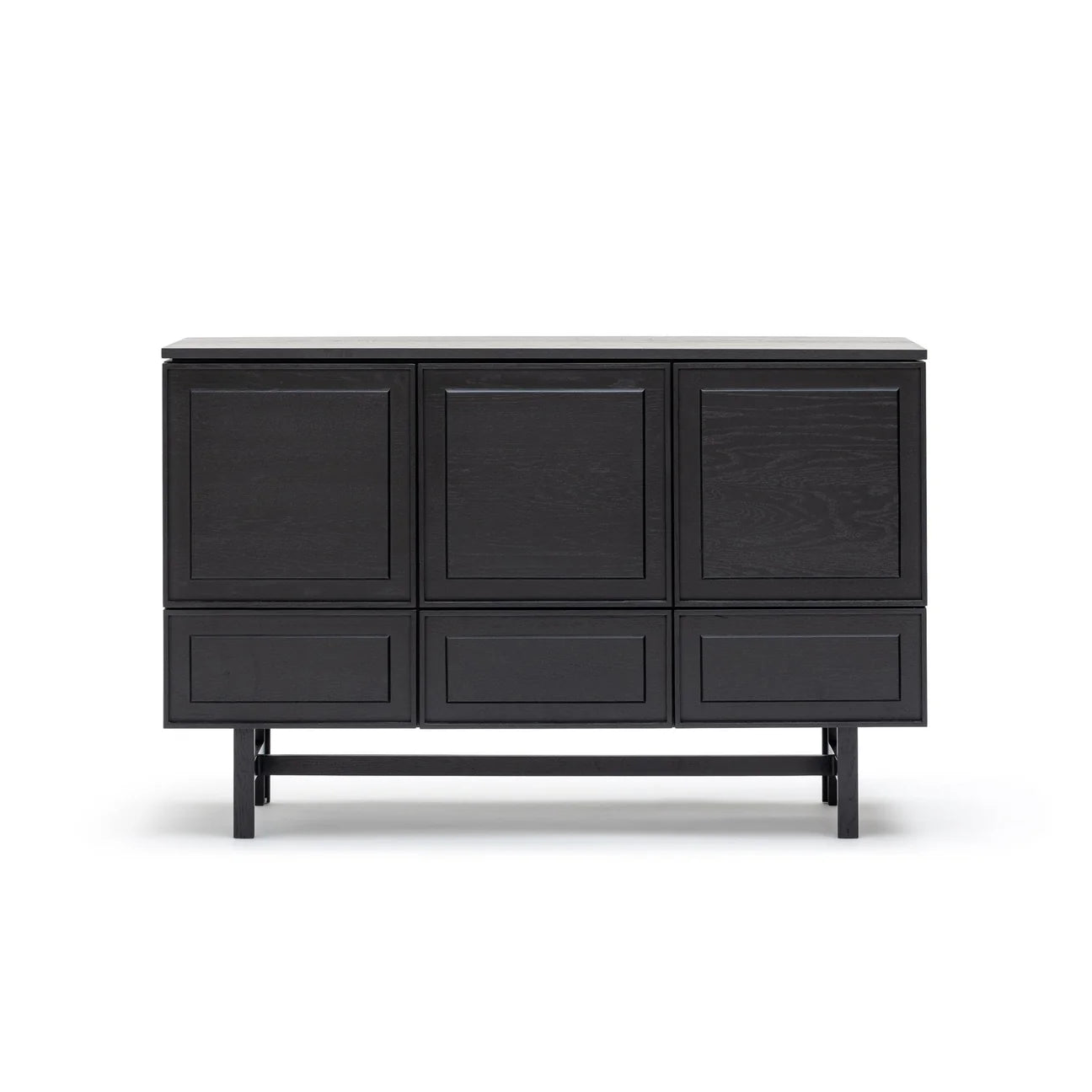 The Yorke Highboard by Wooden Stories is a black wooden sideboard with three doors and three drawers, showcasing minimalist Danish-inspired design and elevated on slim legs against a white background.