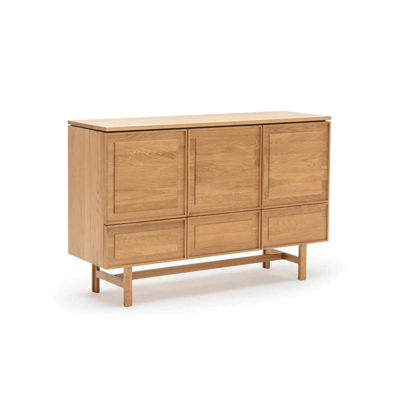 The Yorke Highboard by Wooden Stories is a Danish-inspired wooden sideboard in light oak, with three upper cabinet doors, three lower drawers, and four straight legs.